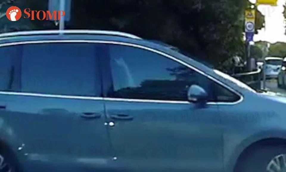 Woman makes hand gesture at driver after squeezing into lane -- in front of kids