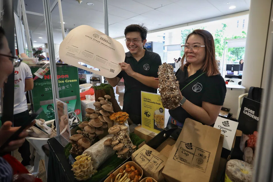 Mr Ong (left) and Ms Audrey Chong, head of marketing of Spore Gardens, travel to different farmers' markets around Singapore to sell their produce.