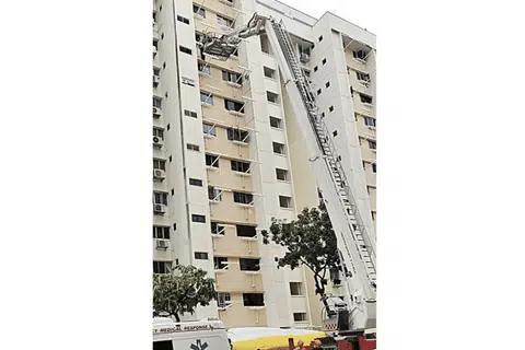 The maid stood on the ledge for about an hour before she was rescued.