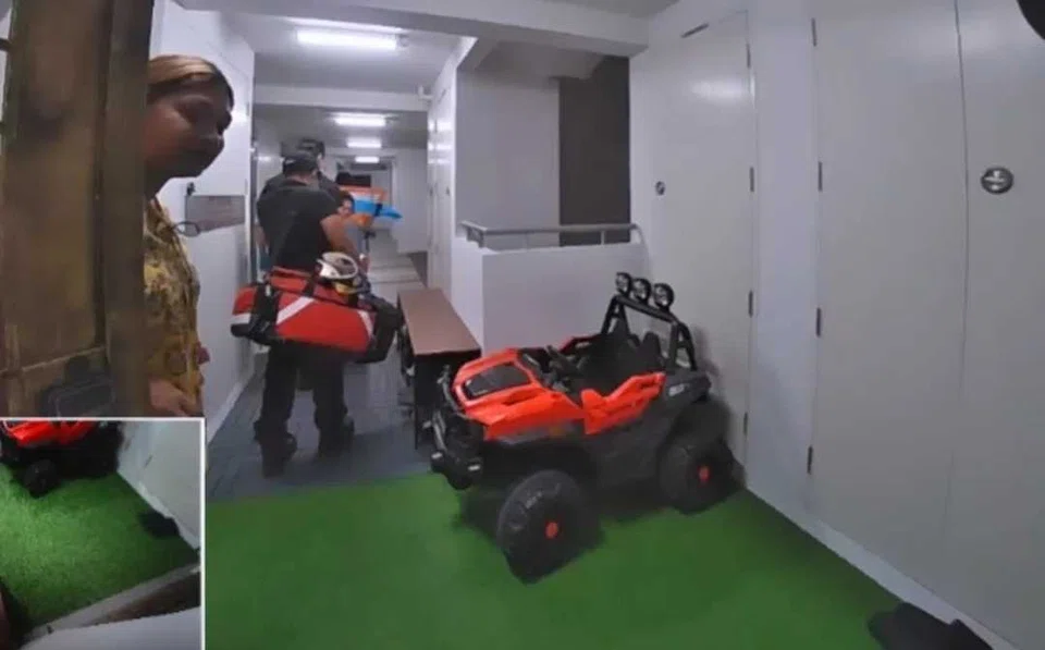 Ms Latashni Gobi Nathan (left) at her neighbour Nur Amalina's gate after paramedics left following the home delivery of a baby girl.