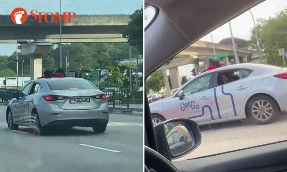 The video shows the silver Mazda with the heads and shoulders of two people above the roof of the car coming to a stop at the traffic junction that joins Punggol East road.