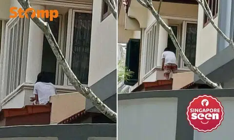 Maid painting outside window at Toh Tuck Crescent