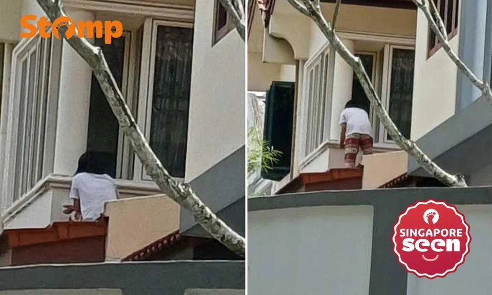 Maid painting outside window at Toh Tuck Crescent