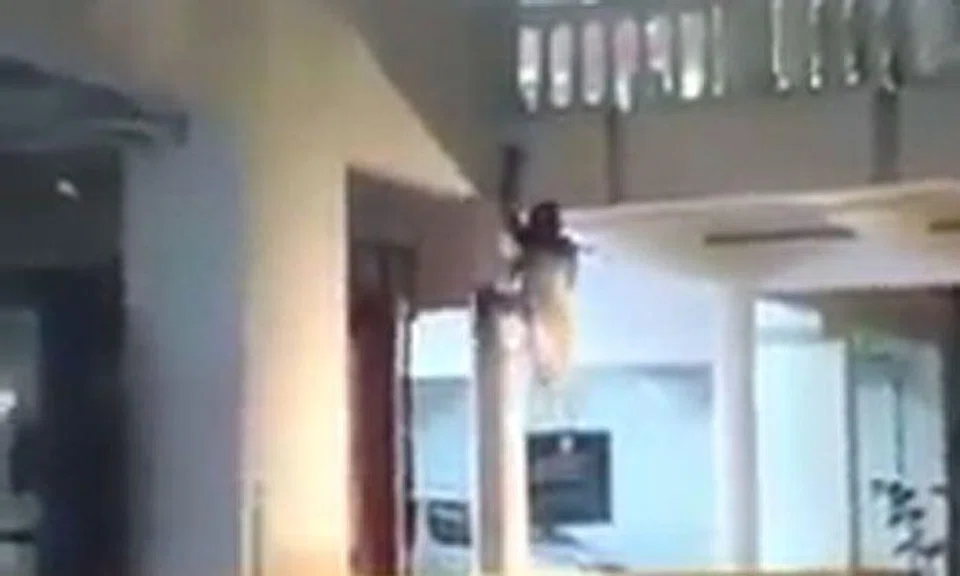 Video of woman in white crawling up pillar will give you chills