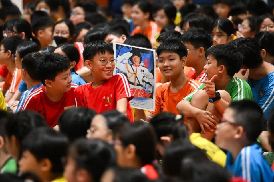 A Pei Chun Public School pupil holding a poster of Jackie Chan on July 7.