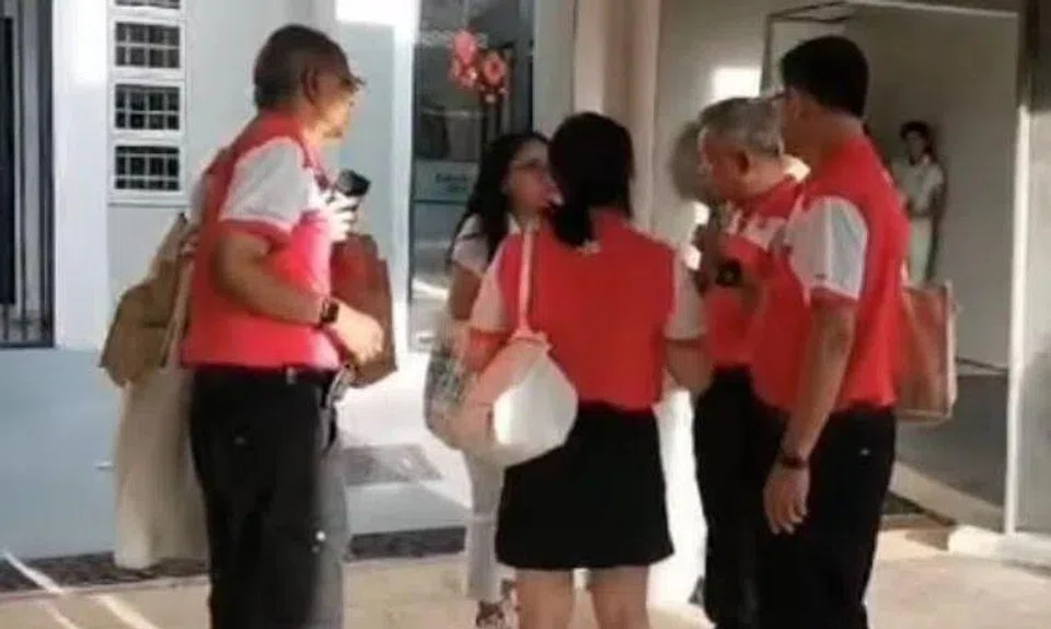 One of the videos released by Mr Azman Ibrahim shows a group of PSP members standing in a circle speaking to an unidentified female PAP volunteer.