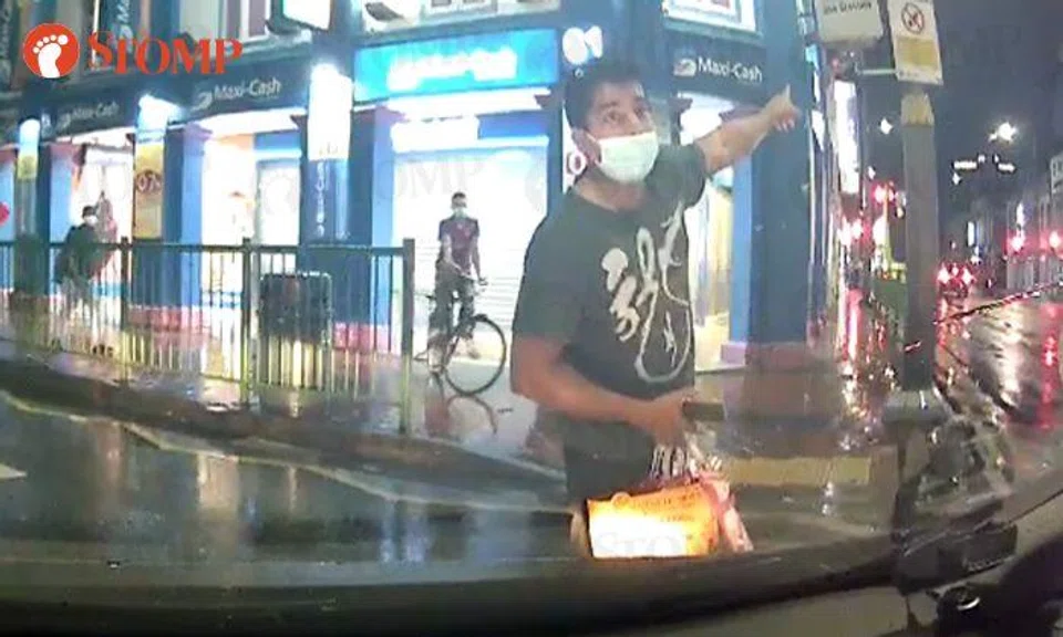 Pedestrian uses phone while crossing road, argues with driver after getting honked at