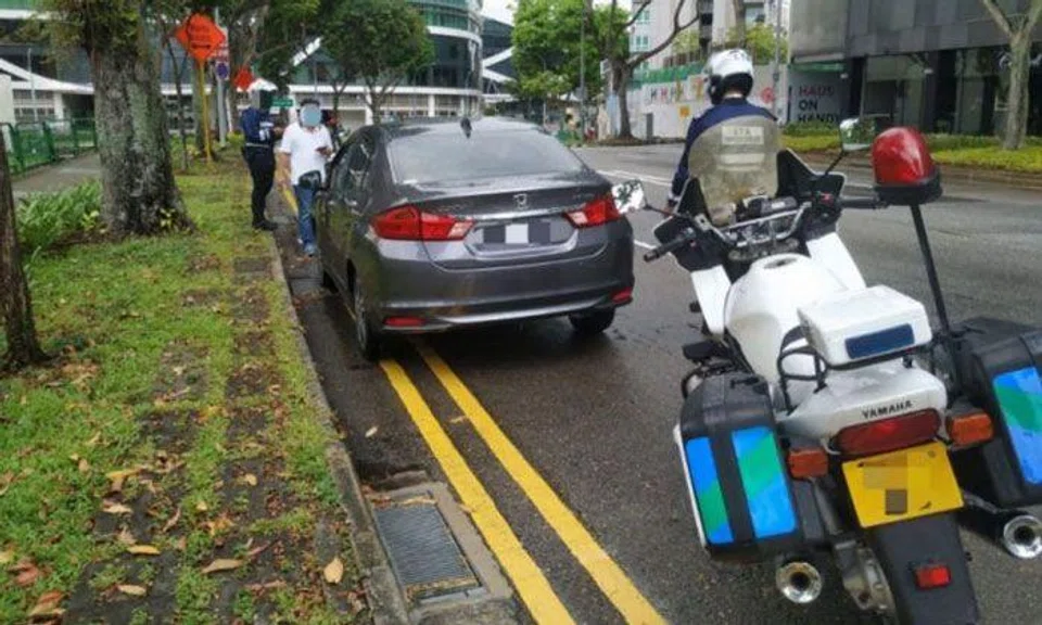 LTA officers conducting enforcement operations against illegal car-pooling services along Handy Road on April 22-23. PHOTO: LAND TRANSPORT AUTHORITY