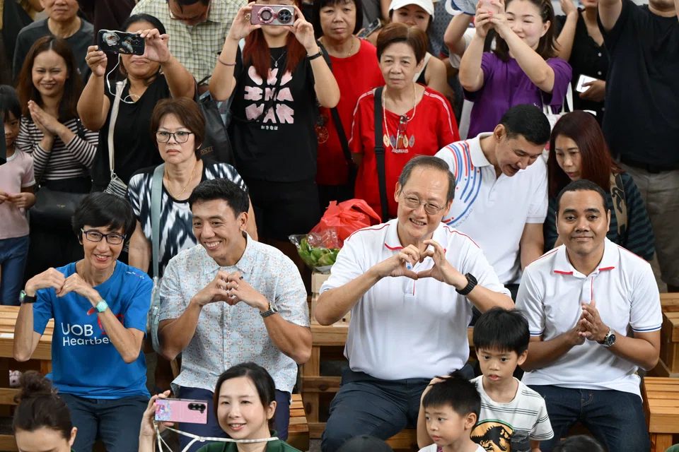 Mr Jeffrey Siow (second from left), Manpower Minister Tan See Leng (second from right) and Mr Zhulkarnain Abdul Rahim (right) watching a performance at Brickland Green Festival 2025 on May 17.