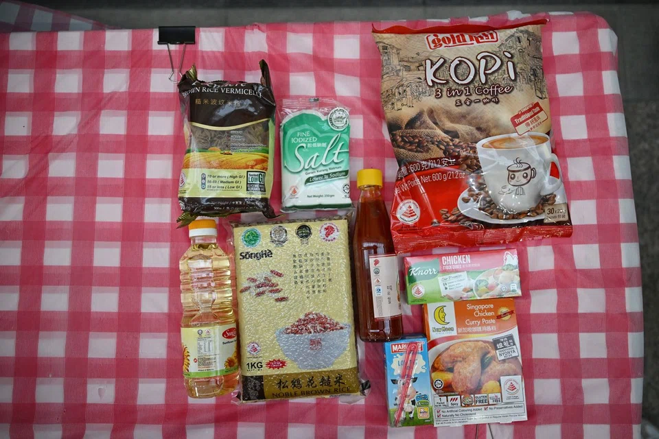 Items in the packs in 2025 all carry the Healthier Choice symbol and examples of the products include lower-sodium salt and whole grain brown rice.