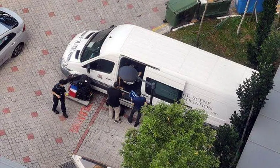 A CID vehicle outside a block in Ang Mo Kio Street 23 on Jan 12, 2022. A woman was found dead in a second-floor unit in the morning. PHOTO: SHIN MIN DAILY NEWS READER