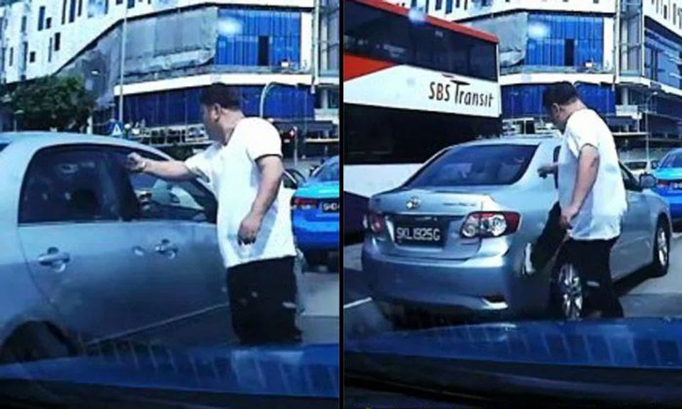 Man gestures angrily at driver in the middle of road, then punches and kicks car when the other does not step out