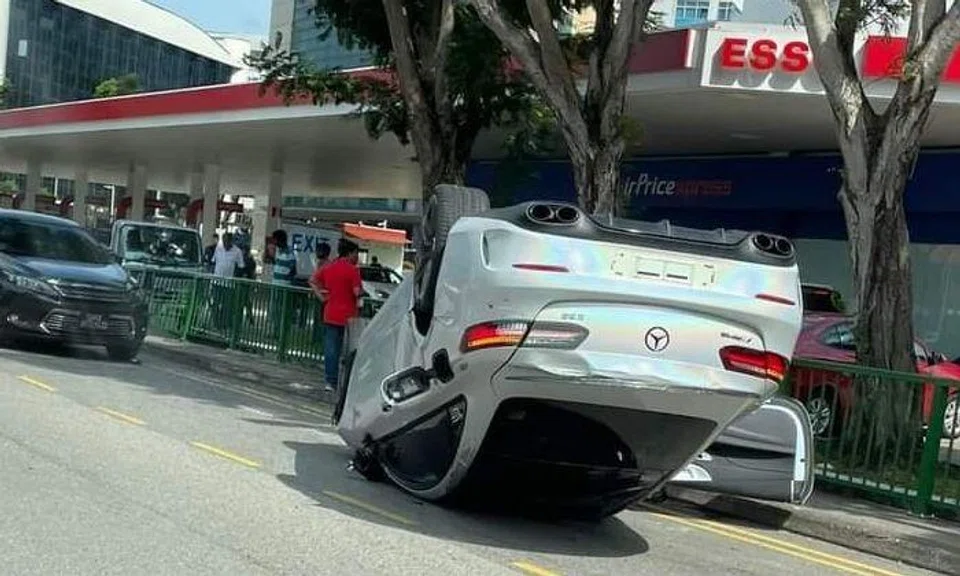 A Mercedes-Benz overturned after an accident involving three cars, lorry and cyclist at MacPherson Road on Saturday (Feb 18).