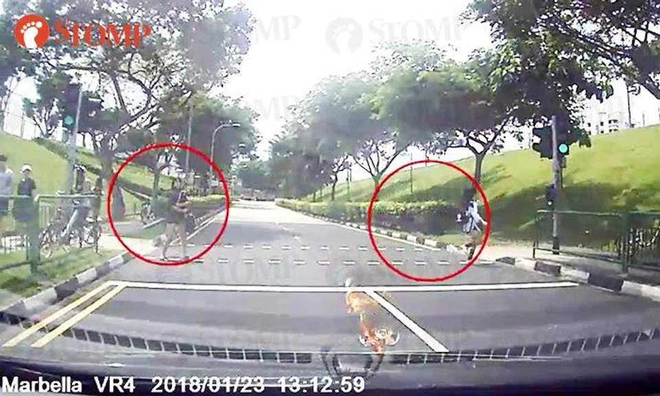 Students blatantly disregard traffic rules by jaywalking and nearly getting knocked down