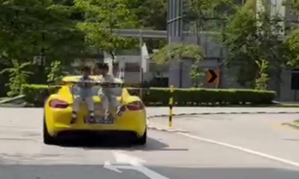 Police probe ongoing after online clip shows Porsche moving with 2 kids sitting atop rear