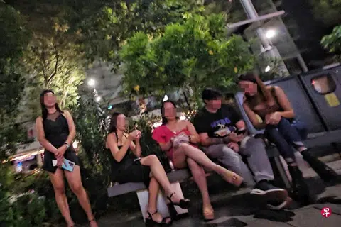 A scantily clad woman seen approaching passers-by outside Forum The Shopping Mall along Orchard Road.