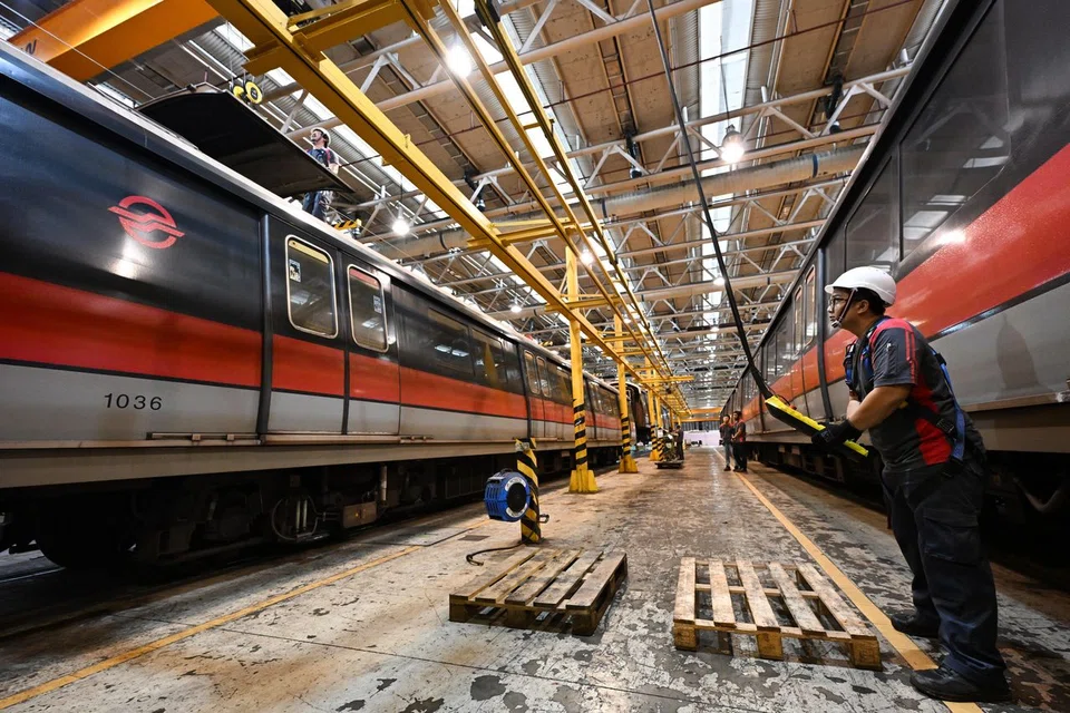 A hatch cover - or the train's roof, which contains its air-conditioning system - is reinstalled, and a pair of doors replaced after being serviced. 