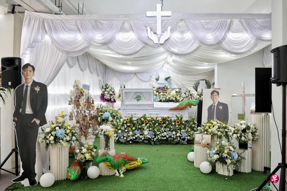 A standee of Nathaniel Zachariah Tan in his wedding suit was placed at his funeral wake. 