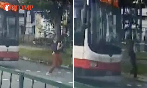 Watch how close woman came to getting run over by bus while running across road in Sembawang