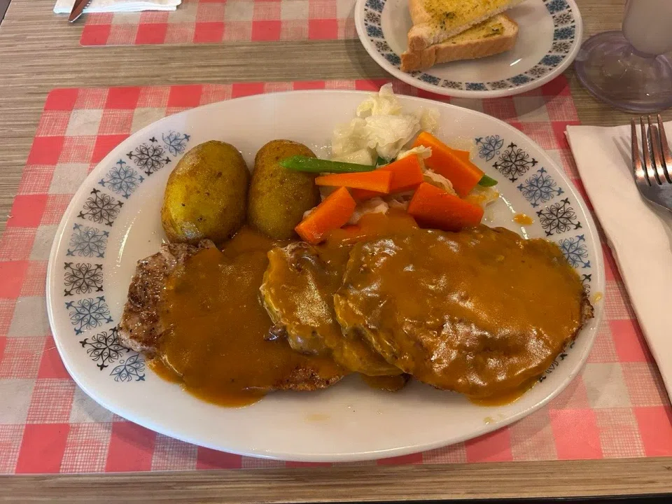 Grilled pork chop from Prince Coffee House, served on 50-year-old plates. ST PHOTO: CHERIE LOK