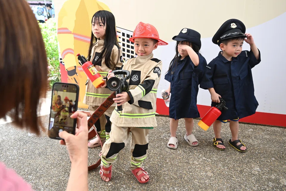 Children dressed up as police officers and firefighters at the Community Resilience Day event.