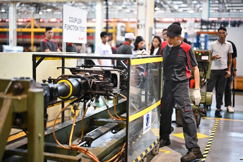 Technical officer Johari Alias, 66, demonstrating a coupler function test inside the workshop at Bishan Depot on March 11.