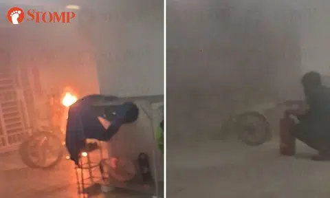 Members of public help put out fire after PAB bursts into flames outside Buangkok HDB unit