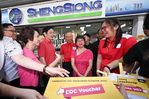 Prime Minister Lawrence Wong and mayors (from left) Alex Yam, Low Yen Ling and Denise Phua with Sheng Siong CEO Lim Hock Chee (fourth from left) and staff of the supermarket chain at Nee Soon South Community Club on May 13.