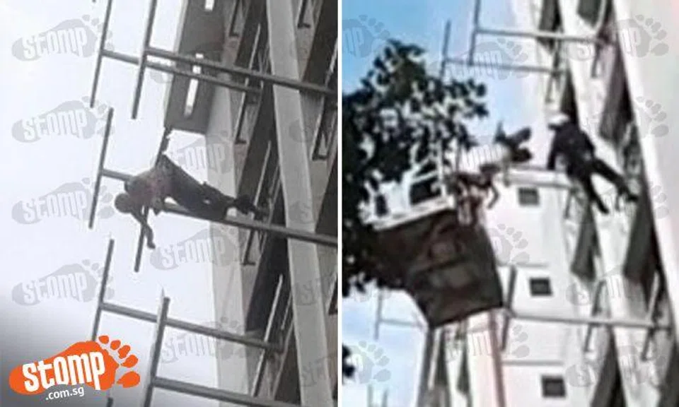 SCDF personnel climb out windows and use fire engine ladder to rescue elderly man on clothes rack at Tampines St 41