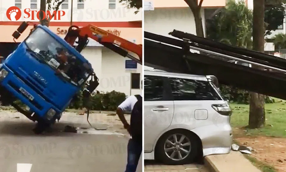 A truck tipped over (left) at a carpark in Geylang Lorong 25, causing a car to be damaged by its hydrualic arm. (right)