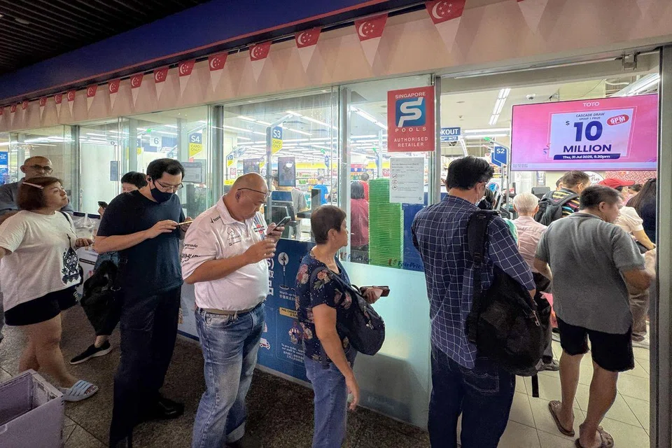 People queueing to buy Toto tickets at the Singapore Pools outlet at Toa Payoh HDB Centre on July 31.