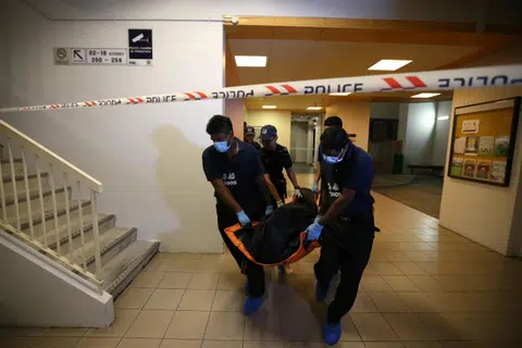 The victim’s body being taken from the crime scene. Zin Mar Nwe’s lawyer said a triggering statement amounted to grave and sudden provocation, which caused her to lose self-control.