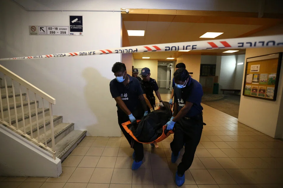 The victim’s body being taken from the crime scene. Zin Mar Nwe’s lawyer said a triggering statement amounted to grave and sudden provocation, which caused her to lose self-control.