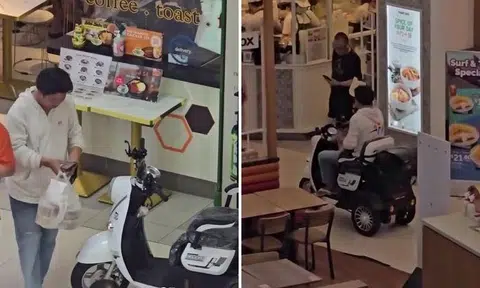 He was seen in the video, which was shared in the Facebook group SG Road Vigilante, to be using his handphone as he walked towards the stall