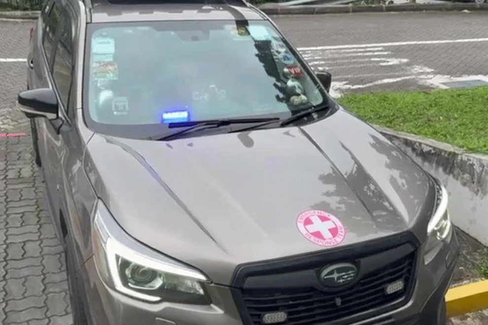 Mr Lin Jin Long's vehicle is equipped with blue emergency lights.