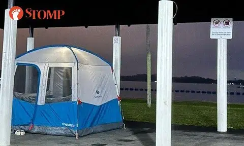 Inconsiderate family sets up camping tent inside Pasir Ris Park shelter where sign says no camping
