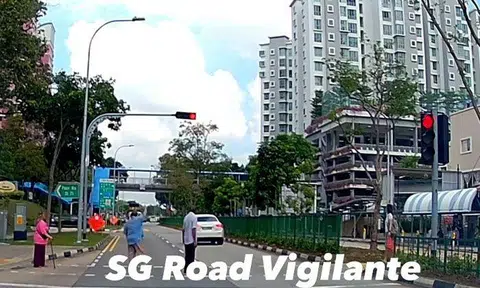 Pedestrians gesture angrily at Maserati driver who runs red light in Pasir Ris