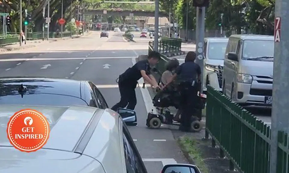 Police officers push 70-year-old PMA rider across road at Ganges Avenue, help him home