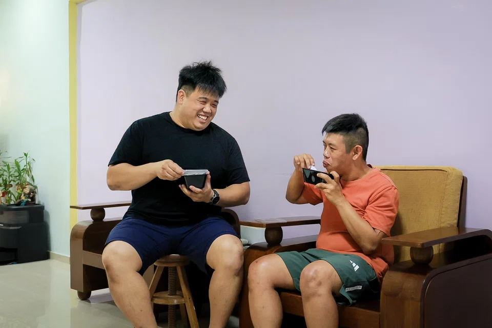 Mr Ryan Ng (left), who helps his parents care for his brother Jarran (right), thinks the ELP will help Jarran transition to living independently.