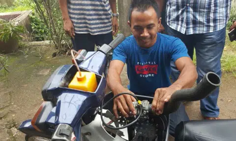 Bike or boat? Malaysian man rides his motorbike through 1.5m flood waters