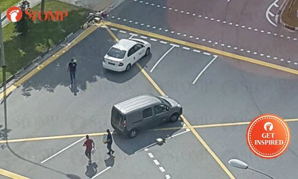 Motorists stop by side of Yishun road to help pick up items that fell from back of van