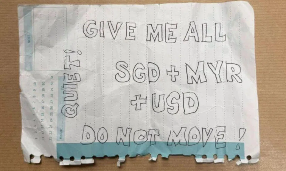 The suspect had shown the victim a handwritten note demanding money.