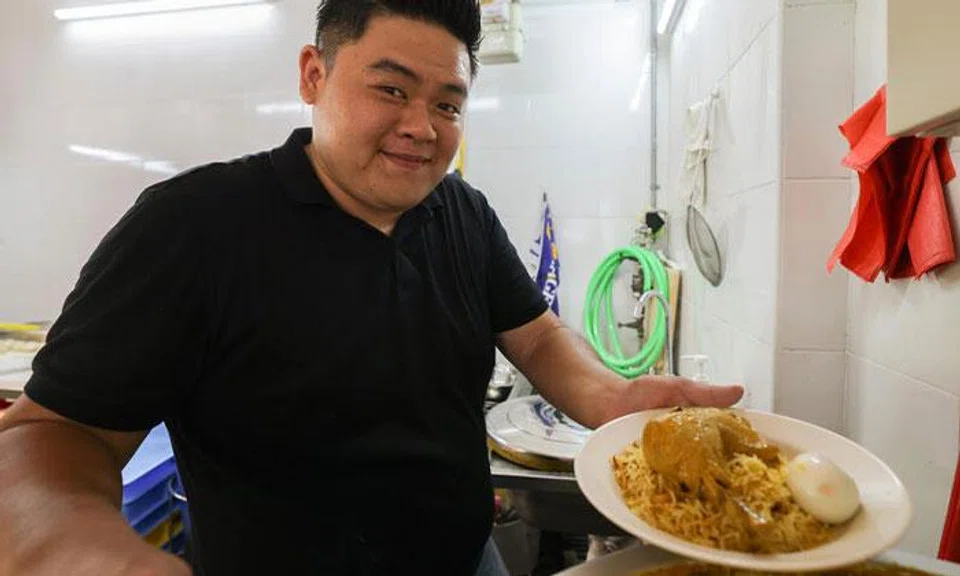Mr Shaun Ho serving a plate of his $5 chicken biryani.