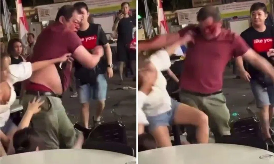 The man forcefully swung at the person behind him and hit the woman in white in the face.