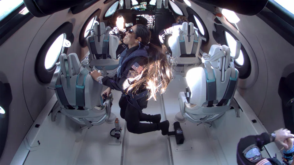 Crew member and scientist Kellie Gerardi enjoying a few minutes of weightlessness on a Virgin Galactic flight.