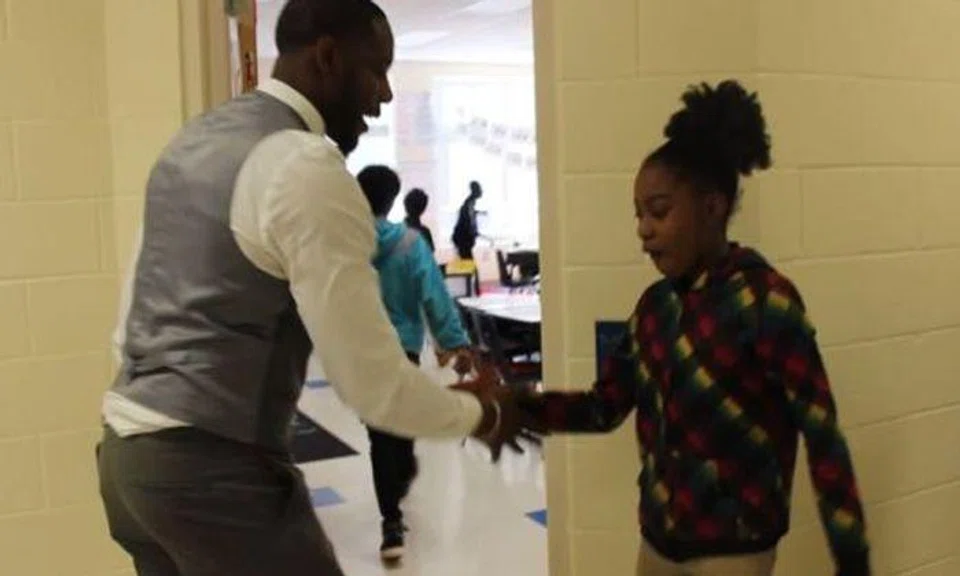 Coolest teacher ever has personalised handshake for every one of his students 