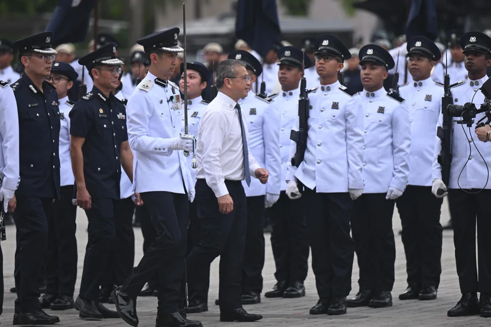 Law Minister Edwin Tong inspecting the parade at the Home Team Academy on June 3.