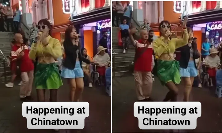 Song and dance by two women in Chinatown as elderly man dances along: 'Got permit or not?'