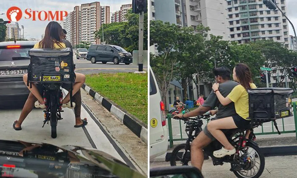 A man and woman rode an electric bike together and ignored a red light at Sengkang. 
