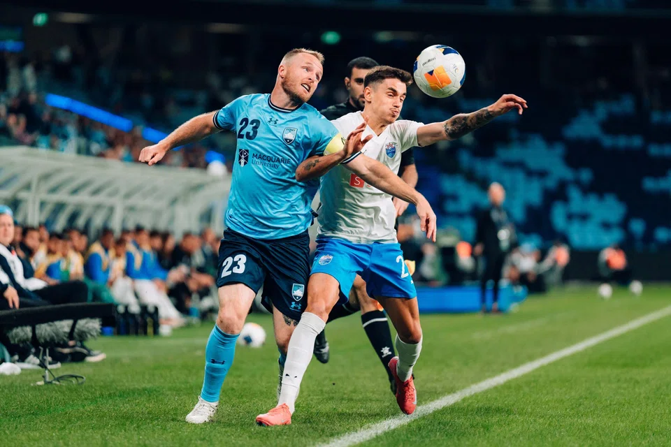 Lion City Sailors defender Diogo Costa (right) vying for the ball with Sydney FC captain Rhyan Grant.
